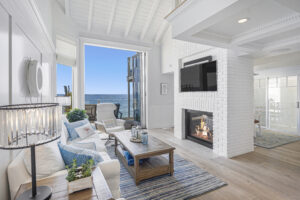 All white living room with fireplace in Malibu House