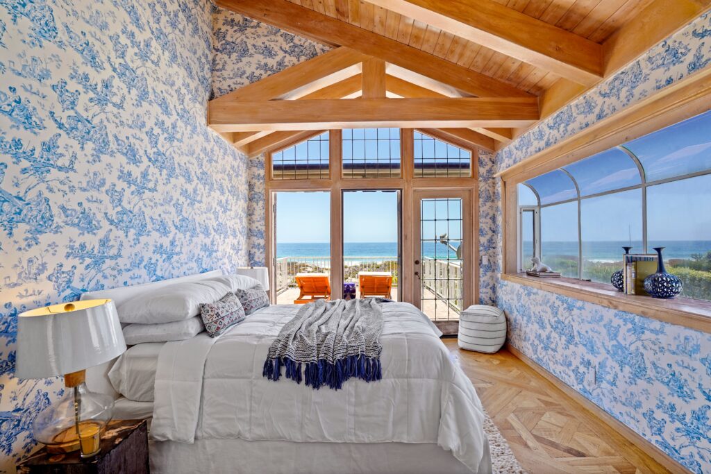 Ocean View Bedroom with Blue Patterned Fabric Walls